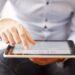 Man-holding-a-digital-tablet-and-reading-news