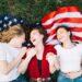 independence-day-concept-with-girls-lying-american-flag