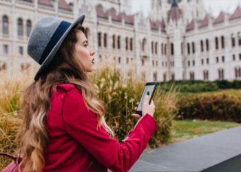 worried-dark-haired-woman-gray-hat-using-gps-while-enjoying-attractions
