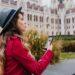 worried-dark-haired-woman-gray-hat-using-gps-while-enjoying-attractions